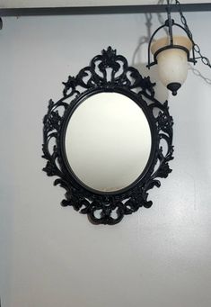 a mirror hanging on the wall next to a light