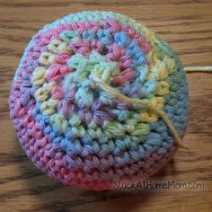 a crocheted ball sitting on top of a wooden table