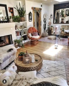 a living room filled with furniture and a fire place next to a wall mounted mirror