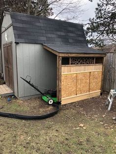 a small shed with a hose attached to it