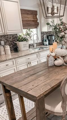 a wooden table sitting in the middle of a kitchen