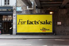 a large yellow sign on the side of a building that says for fact's sake