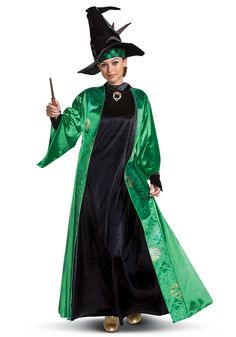 a woman dressed in a wizard costume holding a wand and wearing a black hat with green trim