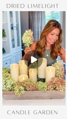 a woman sitting at a table with candles in front of her and the words, dried limelight candle garden