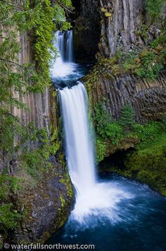 a waterfall is flowing down the side of a cliff