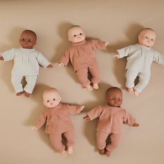 five baby dolls laying on top of each other