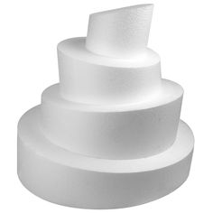 three tiered white cake sitting on top of each other in front of a white background