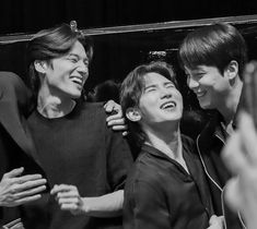 black and white photo of group of people laughing