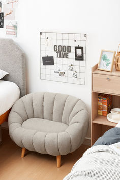 a bedroom with a bed, chair and pictures on the wall above it that says good time