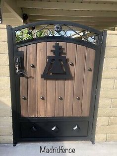 an iron gate with a bell on it and the words madriffene above it