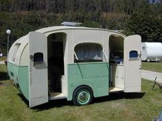 an old camper is parked in the grass