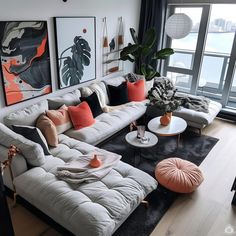 a living room filled with lots of furniture next to a large window and a painting on the wall