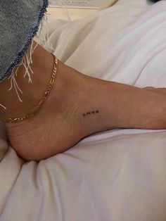 a woman's foot with the word mom written on it and a chain around her ankle