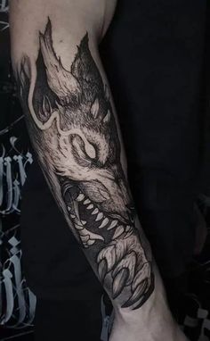 a man's arm with a dragon tattoo on the left side of his arm