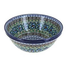 a bowl with blue and green designs on the bottom, sitting in front of a white background