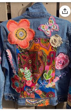 a denim jacket with flowers and butterflies on it