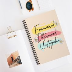 a spiral notebook with the words'empered, determined, unstopable'written on it