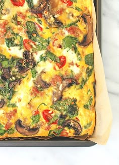 a square pizza sitting on top of a pan covered in cheese and veggies