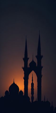 the sun is setting behind an ornate building with spires and minarets in silhouette