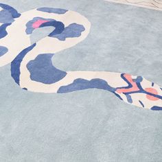 a blue and white rug with a snake on it