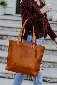 Beautiful. That’s what you call this large saddle tan leather tote bag. The large size is just right, whether you’re carrying a laptop or your favorite pen and journal. The full grain leather with minimalistic design is lightweight for its size. The handmade stitching details make it a fun addition to any outfit — for travel, work, or play. Classic Saddle Shoulder Bag For Everyday, Cognac Saddle Shoulder Bag For Daily Use, Classic Leather-lined Bags For Fall, Everyday Saddle Satchel With Leather Handles, Cognac Saddle Shoulder Bag For Everyday, Everyday Soft Leather Saddle Satchel, Everyday Saddle Bags With Leather Handles, Classic Brown Vegetable Tanned Leather Bags, Cognac Saddle Satchel With Leather Handles