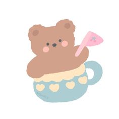 a brown teddy bear sitting in a cup