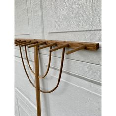 a wooden coat rack hanging on the side of a building