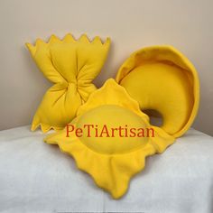 a stuffed animal is sitting on top of a bed with the word pet artisan written below it