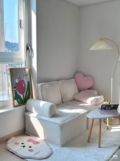 a living room filled with furniture and a large window