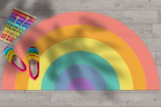 a pair of shoes and crayons are on the floor next to a rainbow rug