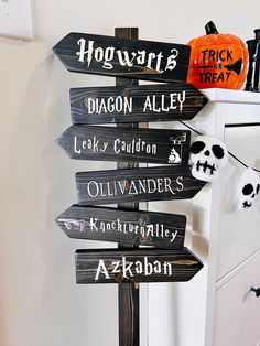 a wooden sign with many different halloween signs on it