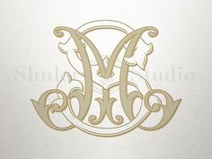 the letter m is made up of gold lines and swirls on a white background