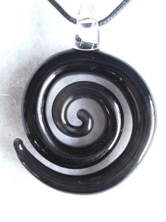 "The spiral is an ancient symbol of the goddess, the womb, fertility, femininity, continual change, and the evolution of the universe. This unique pendant was handcrafted so that each is one-of-a-kind. A simple yet stunning piece sure to turn some heads! Sculpted in the flame and kiln-annealed to ensure durability. Appx 2\", comes in a gift box with a black cotton necklace cord. Please specify your preferred color when checking out. See color chart in last photo for available color options. Chec Spiral Pendant, Unique Black Spiral Jewelry, Cotton Necklace, Spiral Necklace, Cotton Crafts, Ancient Symbols, Unique Pendant, Custom Necklace, Things To Buy