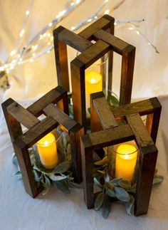 candles are arranged in wooden frames on a table