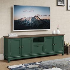 a large flat screen tv mounted to the side of a wooden entertainment center in a living room