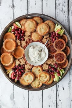 a platter filled with crackers and fruit