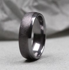 a wedding band that has been made to look like it is in black and white wood