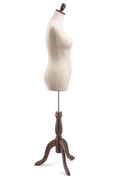 a white mannequin on a wooden stand