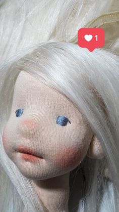 a doll with white hair and blue eyes