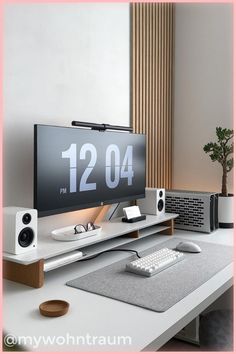 a flat screen tv sitting on top of a white desk