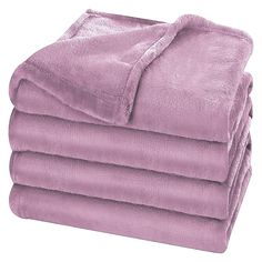 a pile of purple blankets folded on top of each other