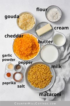 the ingredients to make macaroni and cheese are shown in bowls on a white surface