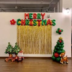 christmas decorations are displayed on the wall in an office space with balloons and streamers