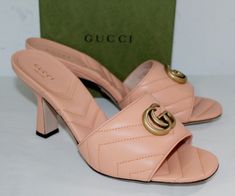 All of My Items are Guaranteed 100% Authentic  You are looking at a beautiful designer pair of shoes made by Gucci Size 40 Heels 3.5" Leather uppers Brand new with box, dust bag and Gucci cards Made in Italy Condition: Authentic and Brand New This is an authentic pair of GUCCI Nappa Matelasse GG Marmont Slide Sandals size 40 in Peachy Chic. These heels are crafted of leather in pink. They feature an antique gold GG logo, a peep toe, and a 3.5-inch block heel. *** Save our store to your favorites to keep up with the latest deals we have available ***  Scottsdale Clothing See other items at the top of the page off to the right Check out my other items.  I shop for bargains and pass on the deals. Communication Please email me via the Ebay message area with any questions or concerns.  Payment Gucci Heels, Chic Heels, Gucci Gg Marmont, Gg Logo, Gg Marmont, Heels Sandals, Slide Sandals, Antique Gold, Leather Sandals