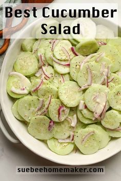 a white bowl filled with cucumber salad on top of a table