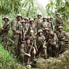 a group of soldiers posing for a photo in the jungle