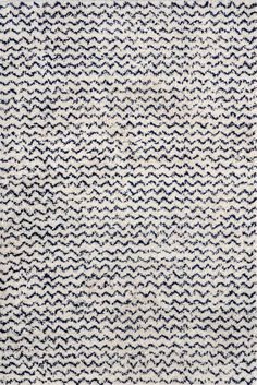 an area rug with blue and white waves on it