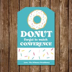 a donut conference sign hanging on a wooden fence with the words donut forget to watch