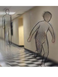 two people walking down a long hallway with black and white checkered flooring