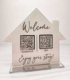 a glass house with the words welcome and qr code on it